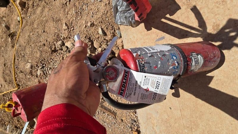 At least one fully charged, serviceable fire extinguisher on site with current inspection tag